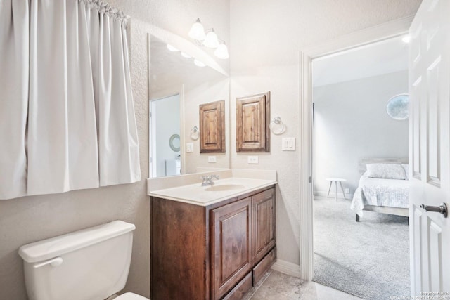 bathroom featuring toilet and vanity