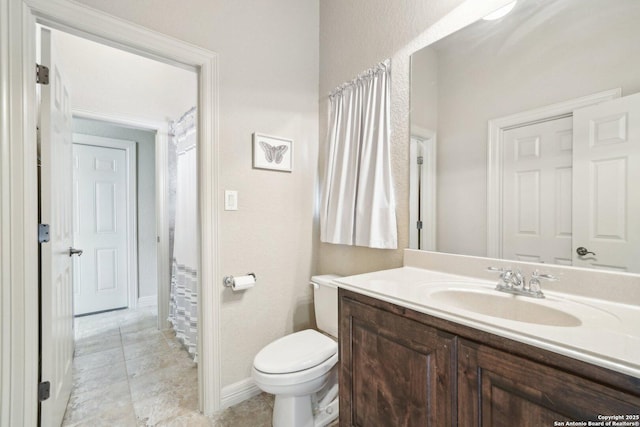 bathroom with toilet and vanity