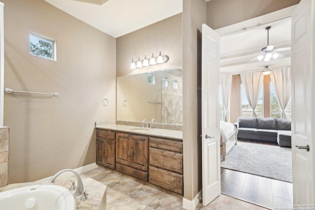 bathroom with ceiling fan and vanity