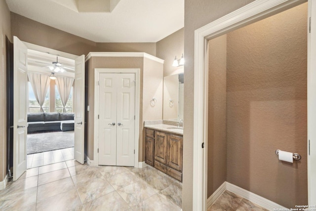 bathroom with ceiling fan and vanity