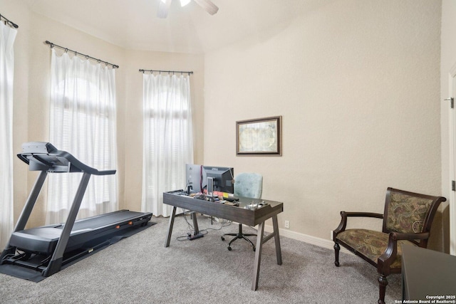 carpeted home office featuring ceiling fan