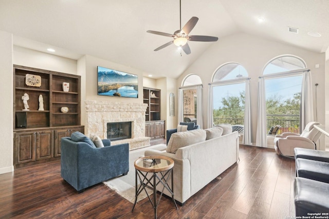 living room featuring ceiling fan, dark hardwood / wood-style floors, high vaulted ceiling, and a fireplace