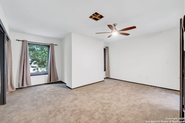 carpeted empty room featuring ceiling fan