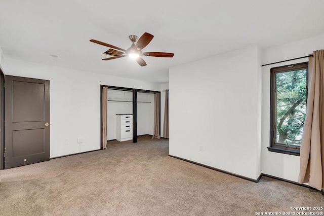 unfurnished bedroom featuring ceiling fan and light colored carpet