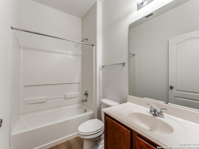 full bathroom featuring toilet, hardwood / wood-style flooring, shower / washtub combination, and vanity