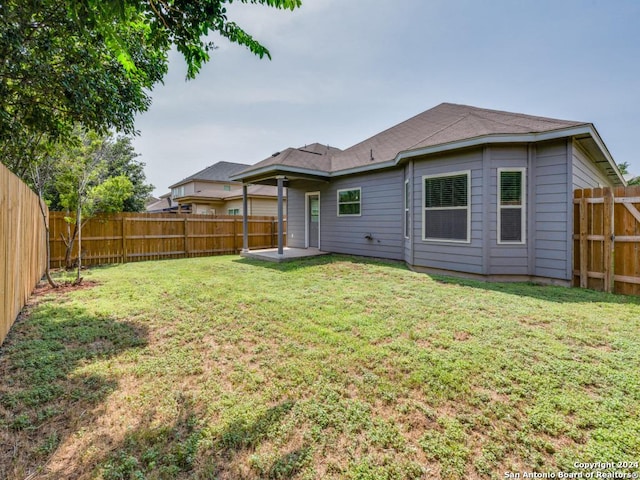 rear view of property with a lawn