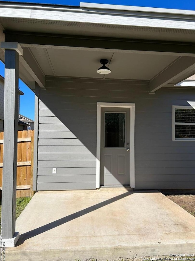 property entrance with ceiling fan and a patio