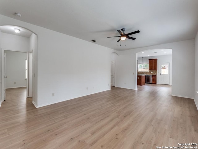 unfurnished living room with light wood-type flooring and ceiling fan