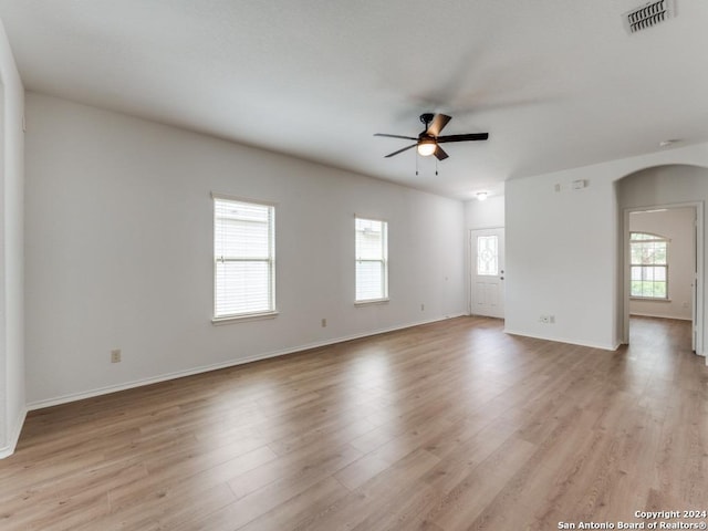 spare room with light wood-type flooring and ceiling fan