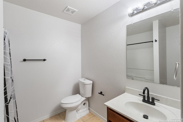 bathroom featuring toilet, tile patterned floors, and vanity