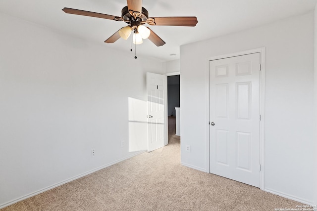 unfurnished bedroom with ceiling fan, a closet, and light colored carpet