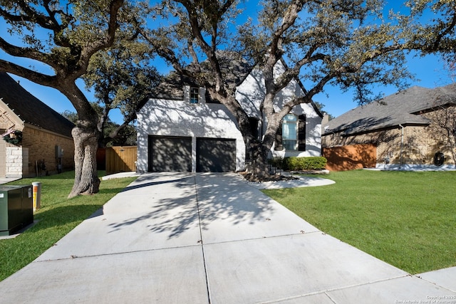 view of front facade with a front yard and a garage