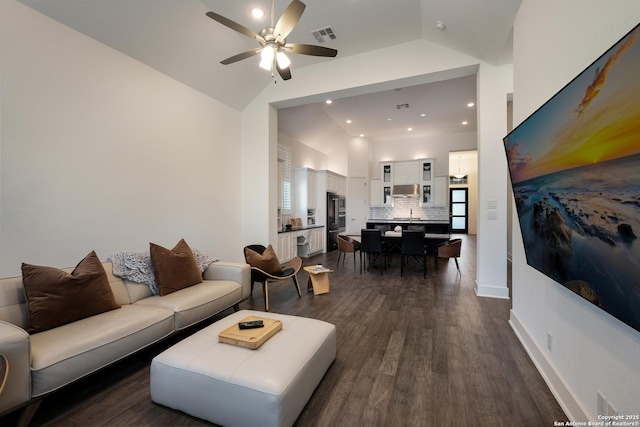 living room with ceiling fan, dark wood-type flooring, and lofted ceiling