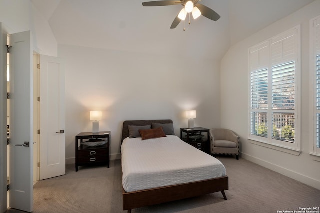 bedroom with ceiling fan, vaulted ceiling, and light carpet