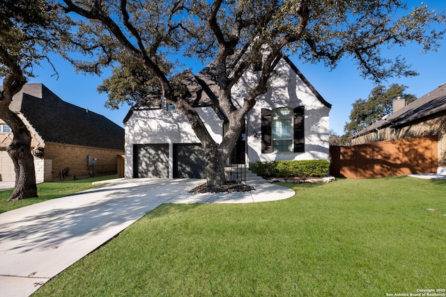 view of front of property with a front yard and a garage