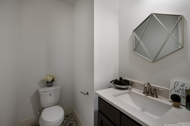 bathroom with toilet and vanity