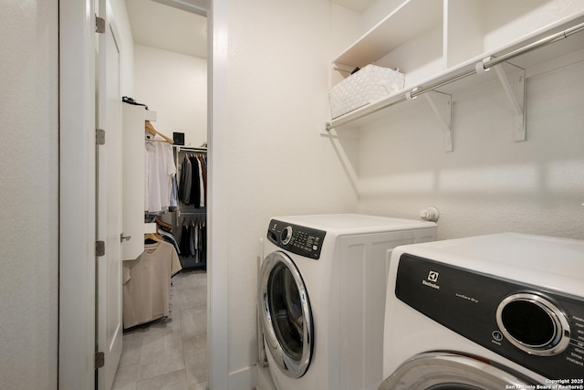 clothes washing area with washing machine and dryer