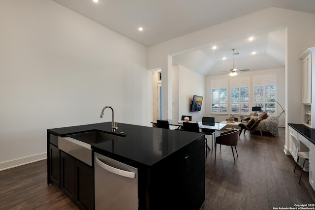 kitchen with an island with sink, ceiling fan, lofted ceiling, dishwasher, and sink