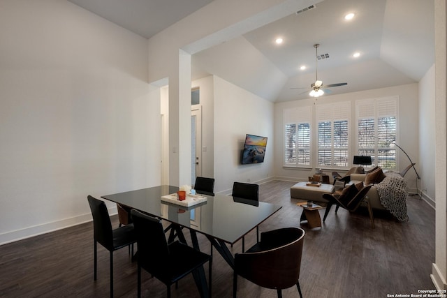 dining space featuring ceiling fan, vaulted ceiling, and dark hardwood / wood-style flooring