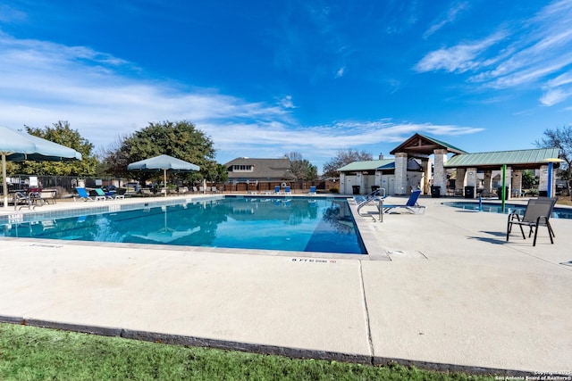 view of swimming pool with a gazebo and a patio