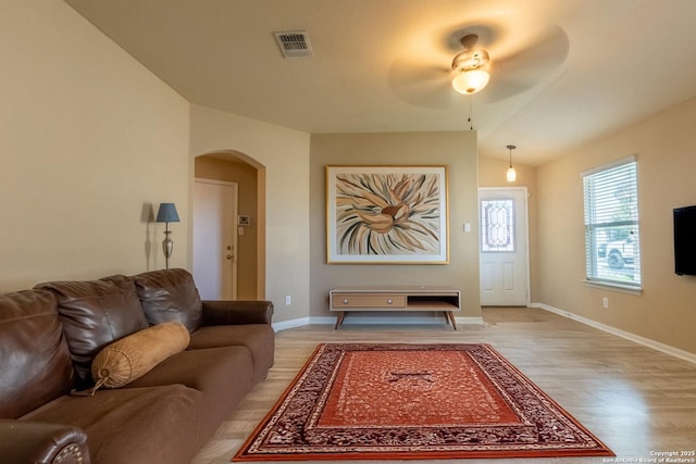 living room with ceiling fan, light hardwood / wood-style flooring, and lofted ceiling