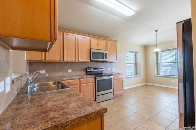 kitchen featuring light tile patterned floors, stainless steel appliances, decorative backsplash, hanging light fixtures, and sink