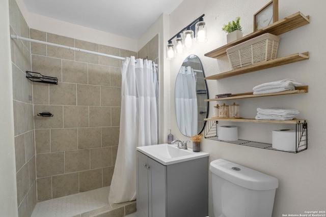 bathroom featuring toilet, a shower with curtain, and vanity