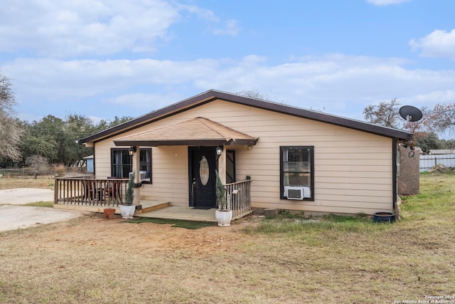 view of front of house with cooling unit and a front lawn