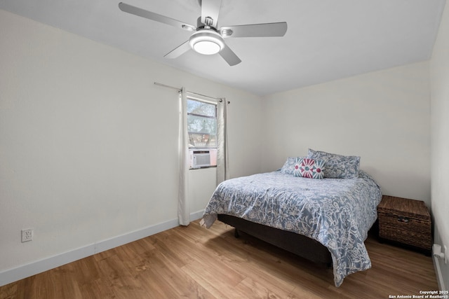 bedroom with ceiling fan, hardwood / wood-style floors, and cooling unit