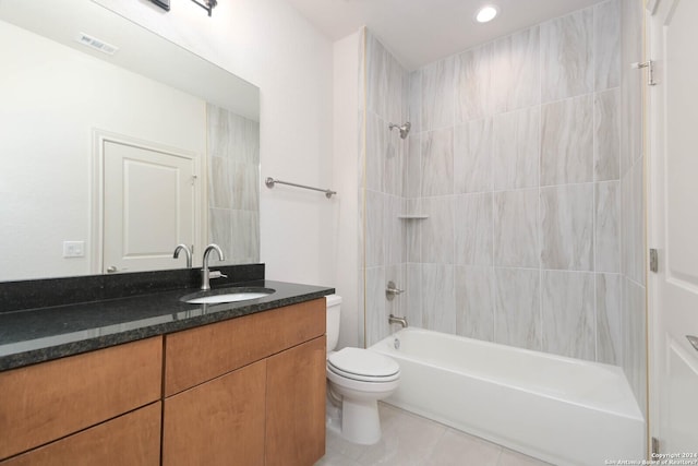 full bathroom featuring toilet, tiled shower / bath, tile patterned flooring, and vanity