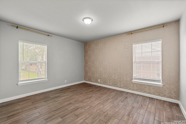 empty room with light hardwood / wood-style flooring