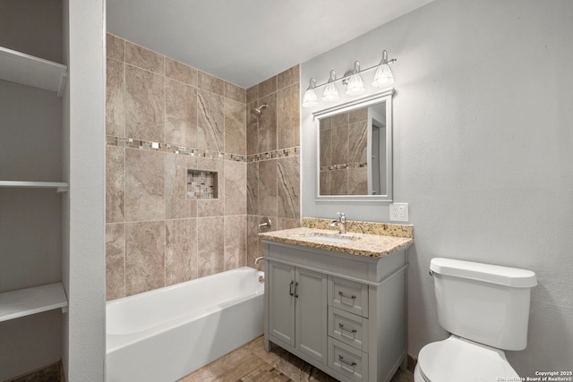 full bathroom with toilet, tiled shower / bath combo, and vanity