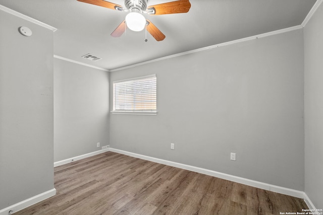 spare room with ceiling fan, ornamental molding, and light hardwood / wood-style floors