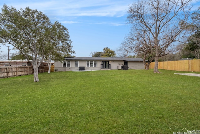 rear view of property featuring a yard