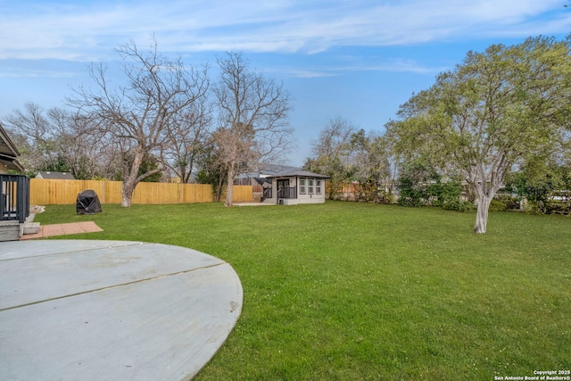 view of yard with a sunroom and a patio