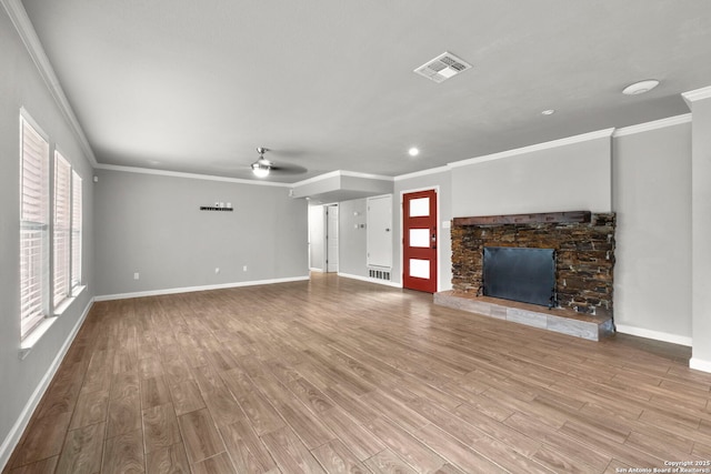 unfurnished living room with ceiling fan, light wood-type flooring, crown molding, and a stone fireplace