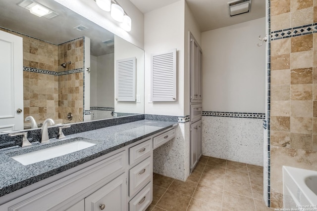 7926 Broadway Unit 402, San Antonio, TX 78209 - bathroom with vanity, tile walls, tile patterned floors, and a bath