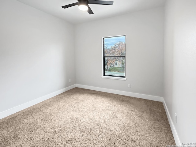 empty room with ceiling fan and carpet flooring