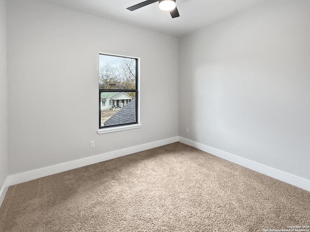 carpeted spare room featuring ceiling fan