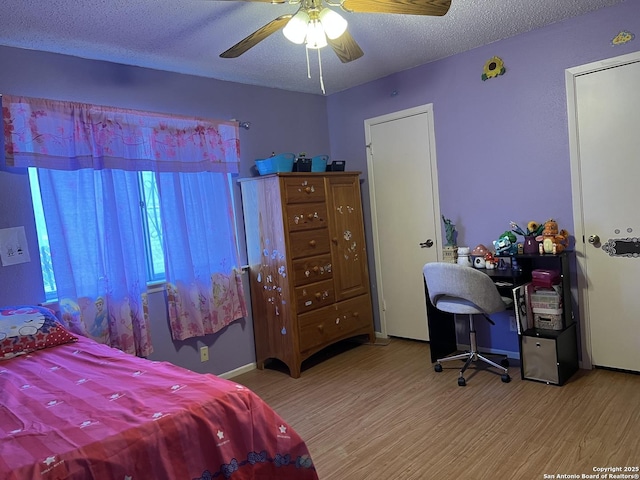 bedroom with ceiling fan, a textured ceiling, and light hardwood / wood-style floors