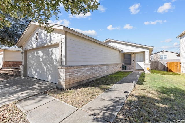 ranch-style home featuring a garage and a front yard