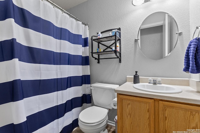 bathroom with toilet and vanity