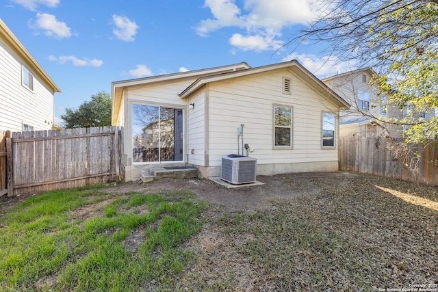 back of house with central AC