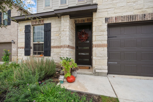 view of exterior entry with a garage