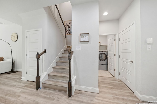 stairs featuring washer / dryer and hardwood / wood-style flooring