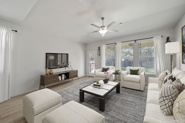 living room with ceiling fan, hardwood / wood-style floors, and lofted ceiling