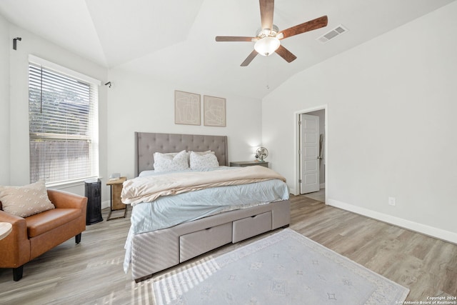 bedroom with ceiling fan, vaulted ceiling, and light hardwood / wood-style floors