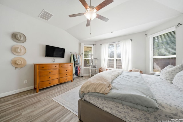 bedroom featuring ceiling fan, lofted ceiling, and light hardwood / wood-style floors