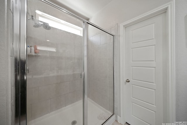 bathroom with a shower with shower door