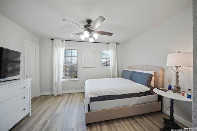 bedroom with ceiling fan and light hardwood / wood-style floors